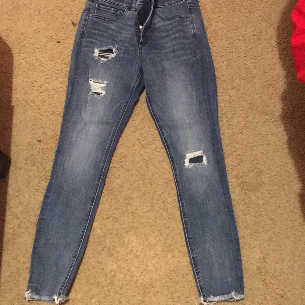 Dark blue jeans , distressed at ends